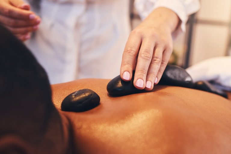 hands hot stone and massage with a man in a spa 2023 11 27 05 13 36 utc